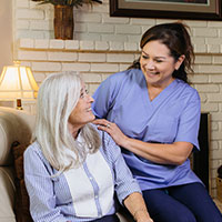 Photo of a Caregiver talking to a senior